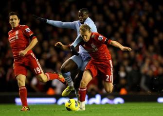 Yaya Toure of Manchester City challenges Lucas of Liverpool during the Barclays Premier League match